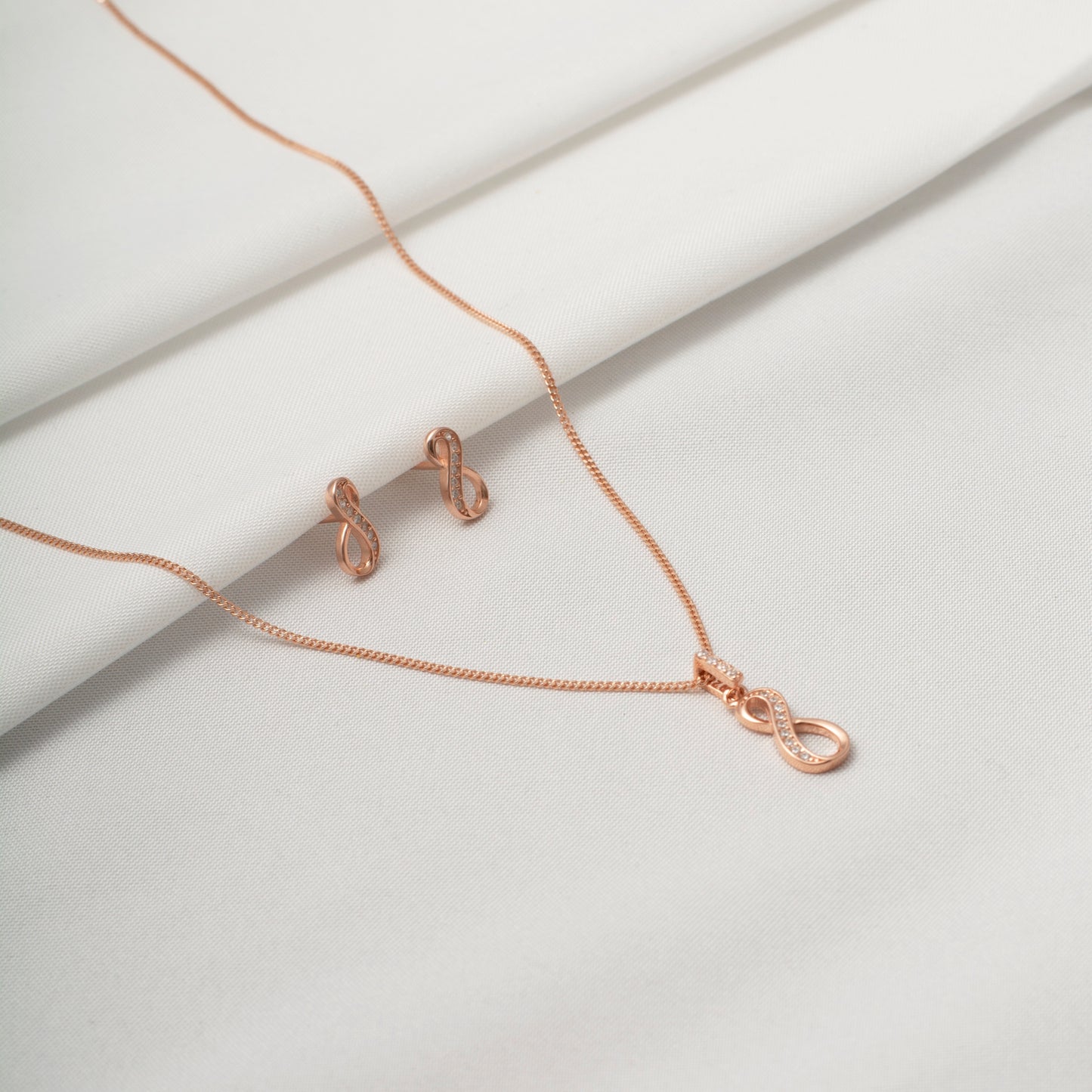 Rose Gold Infinity Pendant and Earring Set with Diamond Accents
