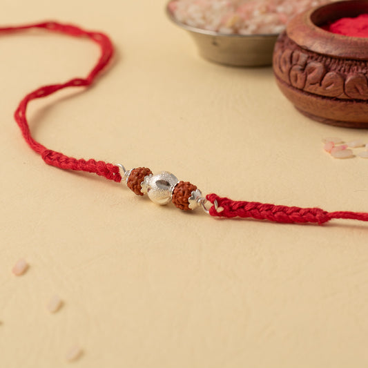 Divine Rudraksha and Floral Motif Silver Rakhi